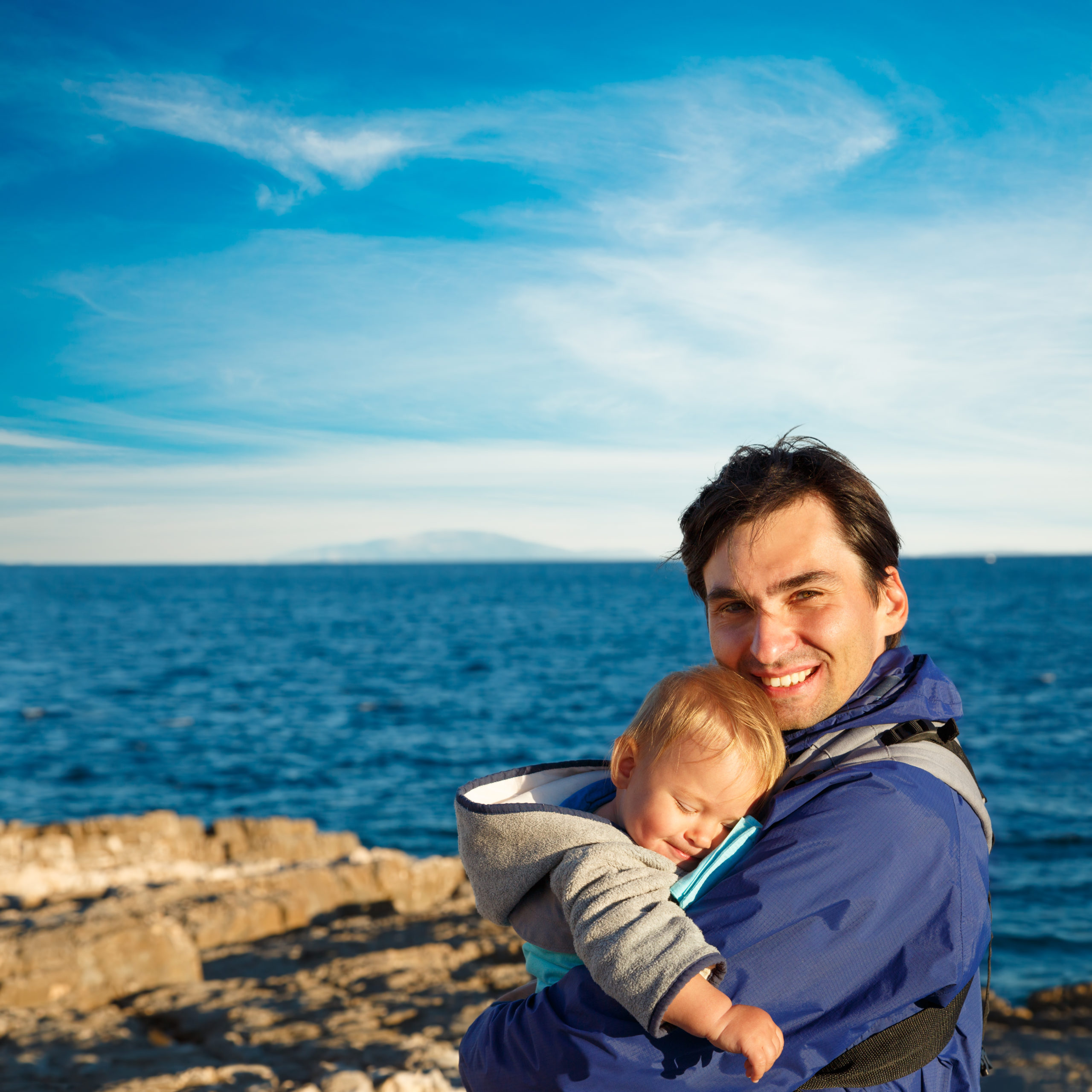 Happy,Father,With,His,Little,Son,In,Carrier,On,Sea