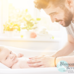 Picture of father massaging a baby