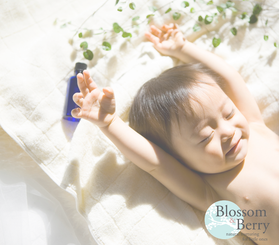 Picture of a baby with arms up in the air and eyes closed