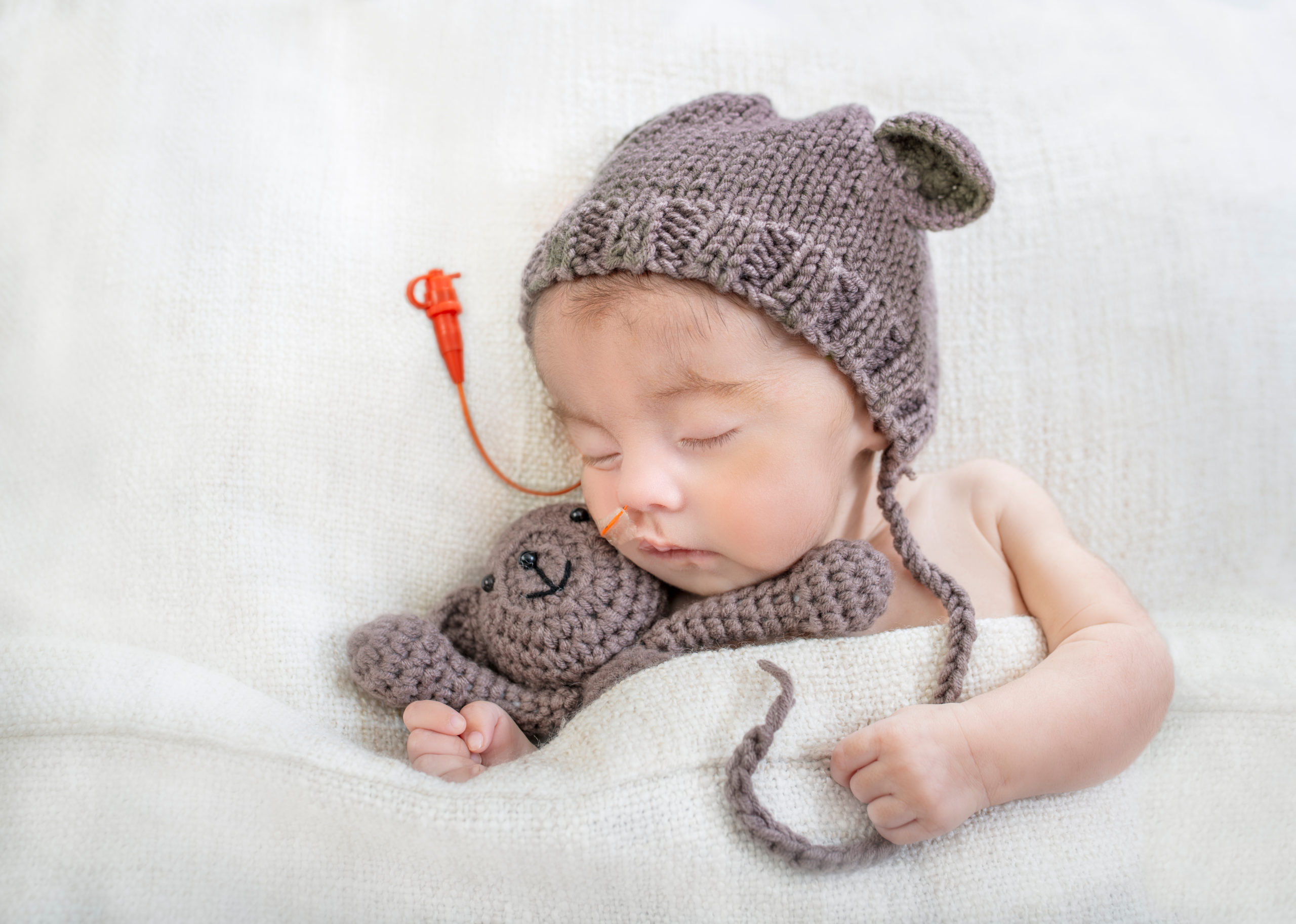 Sleeping,Special,Needs,Infant,With,Feeding,Tube,And,Teddy,Bear