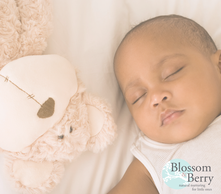 Picture of a baby sleeping next to a teddy bear