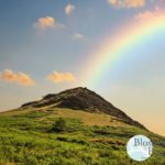 Picture of a mountain with a rainbow over it
