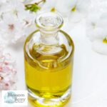 What Is the Best Oil for Newborn Skin? - picture of a bottle of oil on a table covered in flower petals