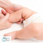 Can I Massage My Baby After a Feed? - picture of a babies legs being massaged my a pair of hands