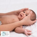 Can I Massage My Baby Twice a Day? Tips for Safe and Soothing Baby Massage - picture of a baby in nappy having their head massaged