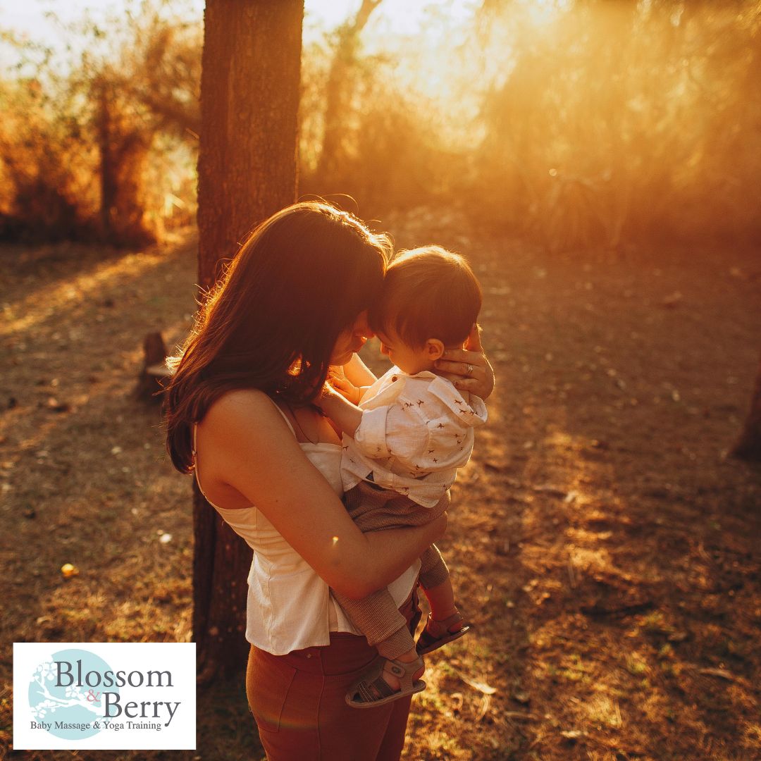 The Benefits of Nature for Parents and Babies: Why Outdoor Time Matters - picture of a mum and baby in a forest with the sun setting