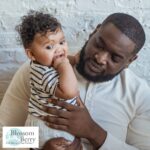 Top Challenges for New Dads - picture of a dad holding a toddler in his arms