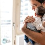 Hands On Dads – Baby Massage for New Fathers - picture of a father holding a baby and stroking it's back
