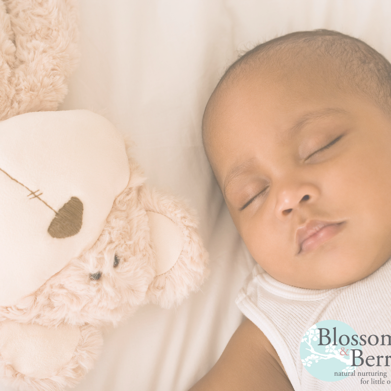 Picture of a baby sleeping next to a teddy bear